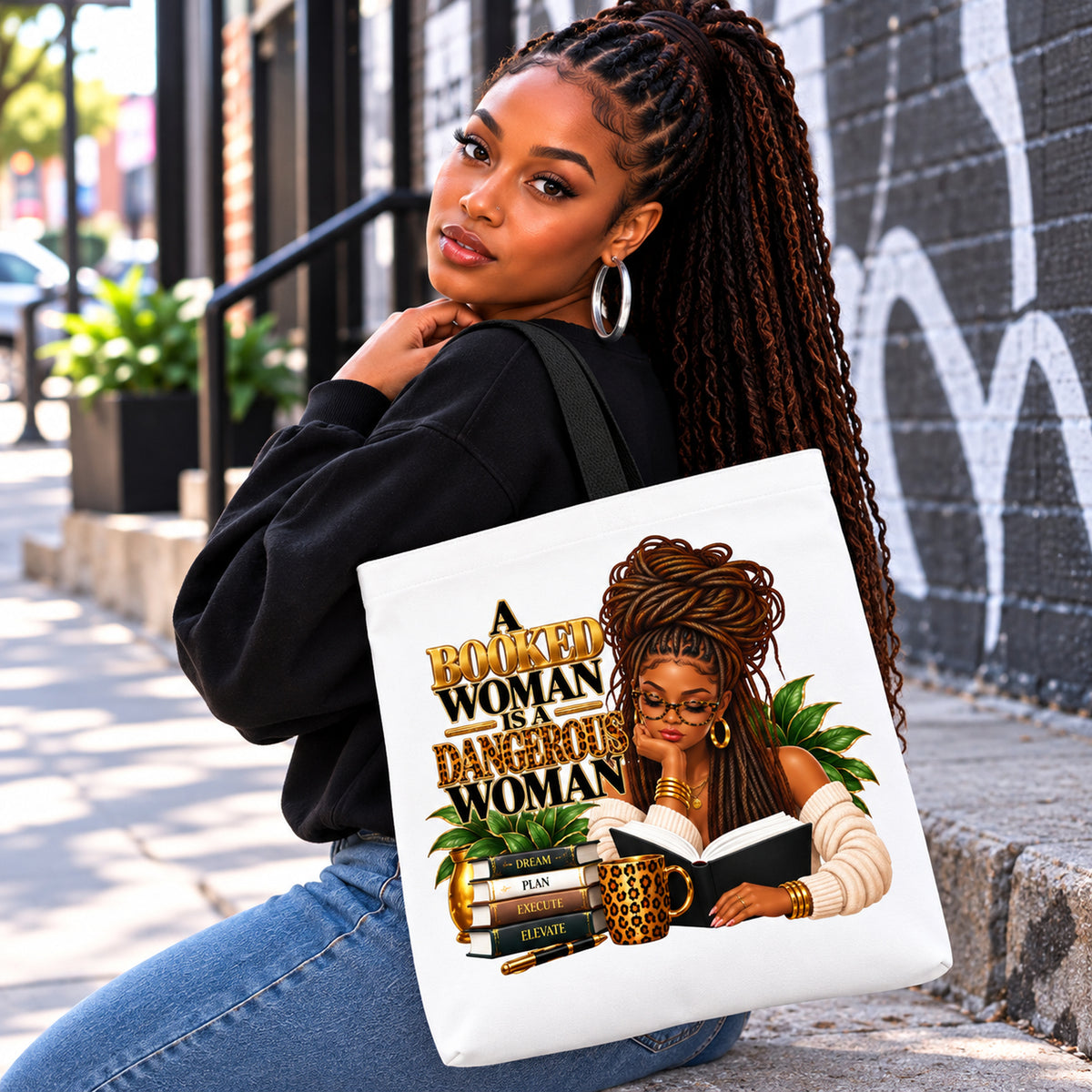 A Booked Woman white tote with black handles modeled by woman with locs